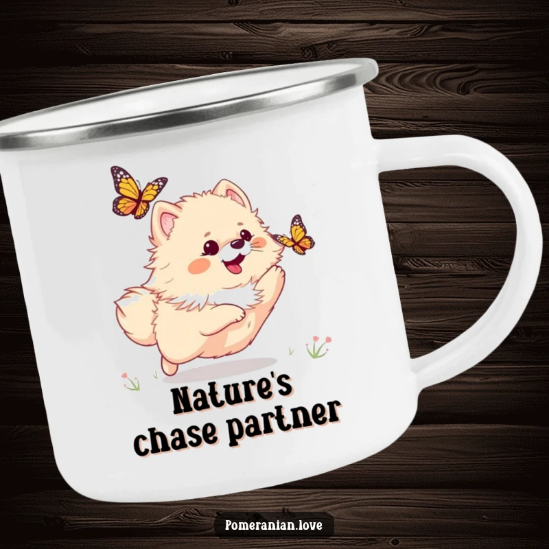 Funny camping mug featuring a playful Pomeranian chasing a butterfly, ideal for enjoying drinks in nature.