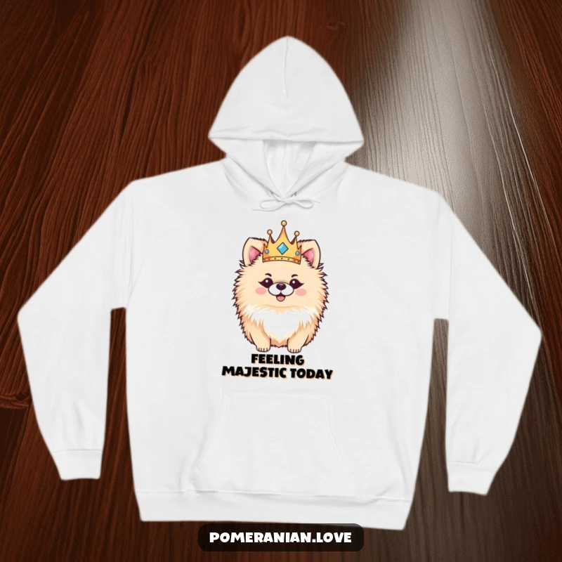 Funny Pomeranian hoodie, a fluffy dog with a tiny crown, looking incredibly happy and regal, perfect for cozy days.