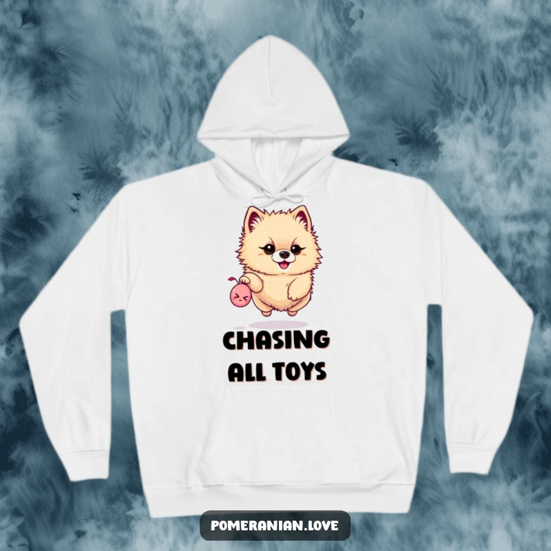 Funny hoodie depicting a determined Pomeranian leaping high to catch a tiny squeaky toy, perfect for playtime.