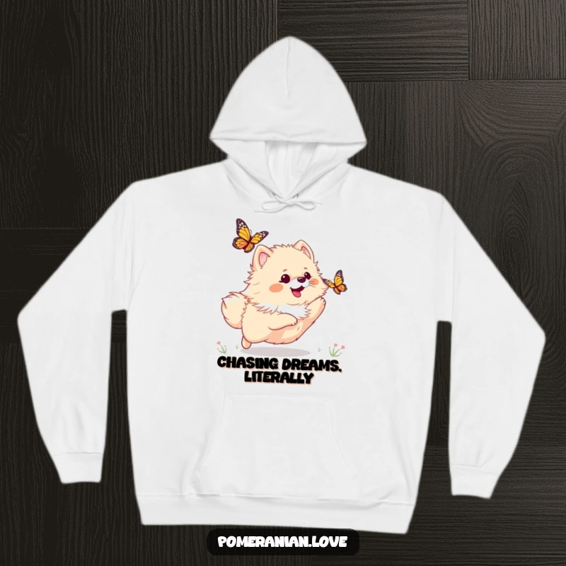 Funny hoodie featuring a playful Pomeranian dog joyfully pursuing a butterfly, offering warmth and a sense of adventure.