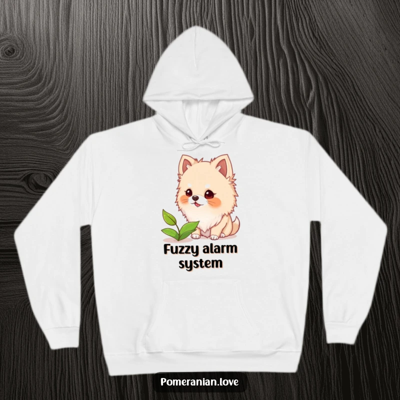 Funny and warm hoodie featuring a Pomeranian dog with fuzzy ears barking playfully at a single leaf floating nearby.