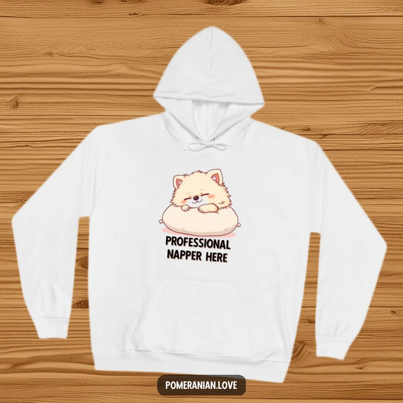 Funny Pomeranian hoodie featuring a content dog sleeping soundly on a cushion, representing ultimate relaxation and cozy vibes. A humorous treat for dog lovers.