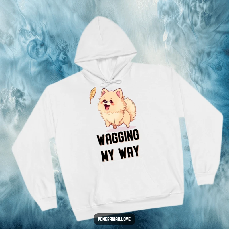 Funny hoodie designed with an excited Pomeranian wagging its tail, playfully trying to catch a feather, perfect for cozy fun.