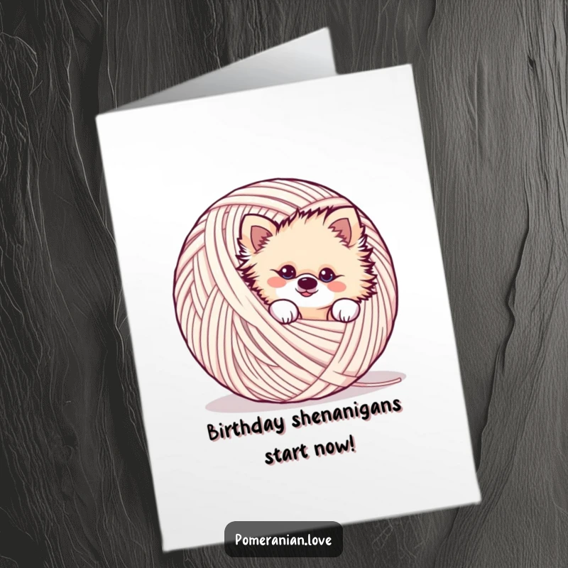 Funny Free Printable Birthday Card featuring a mischievous Pomeranian peeking playfully from behind a large ball of yarn.