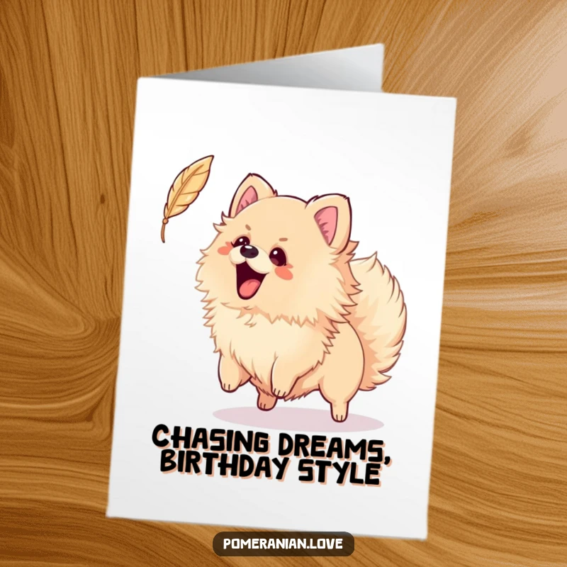 Funny Free Printable Birthday Card: Pomeranian wagging tail, excitedly chasing a falling feather, playful birthday fun.